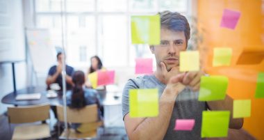 Close-up of male executive reading sticky notes